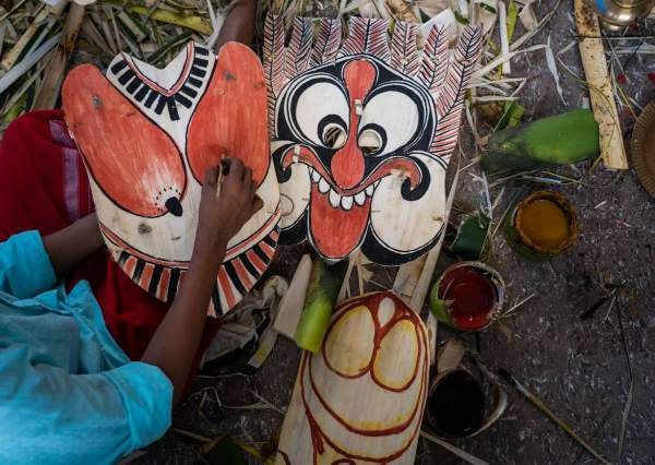 Kolams being painted with natural colors