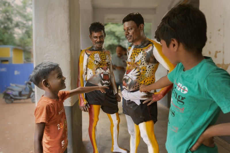 kids delight two children gleefully direct vibrant pulikali performers athira trivandrum creativehut