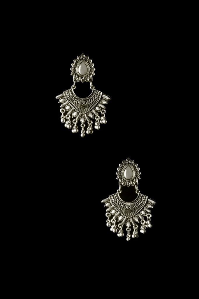 siver earrings in black background