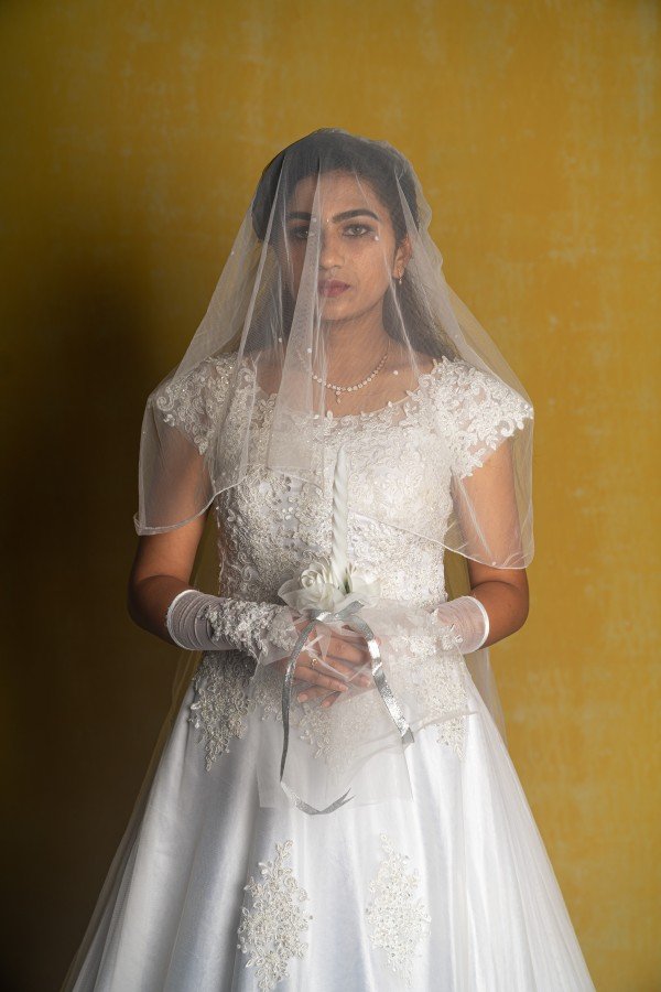 a-girl-in-white-frock-and-covering-her-face-with-white-neck