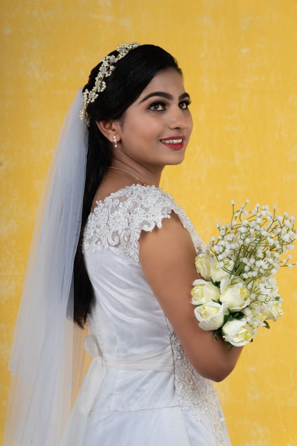 a-girl-in-white-frock-holding-white-flowers-turning-right