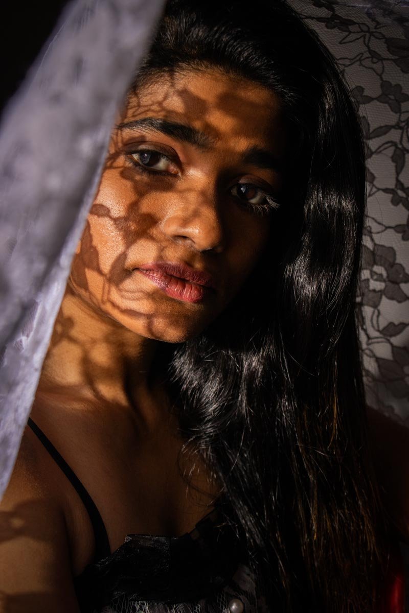 on the girl's face, shadow passes through the lace