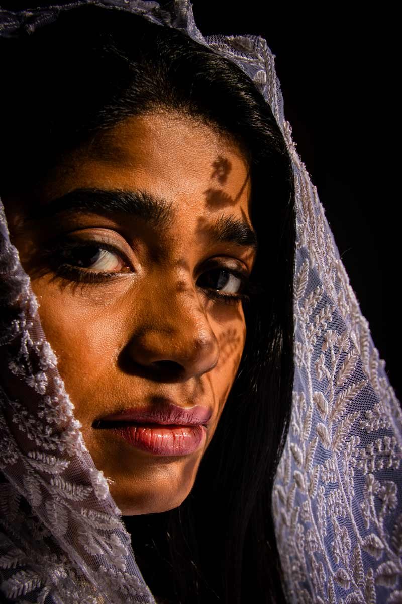 on the girl's face, shadow passes through the lace