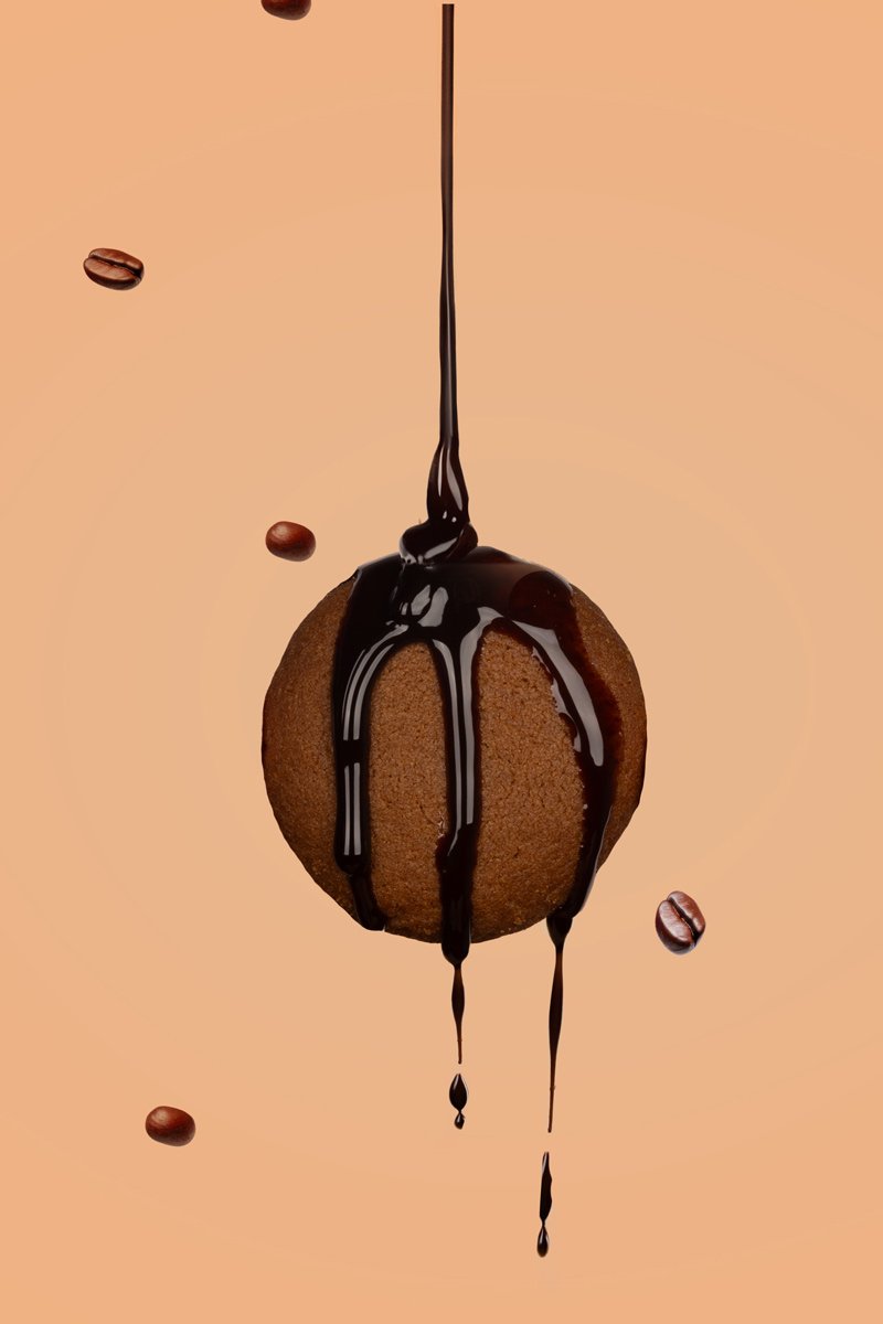 biscuit with chocolate syrup and choco's bins biside of biscuit