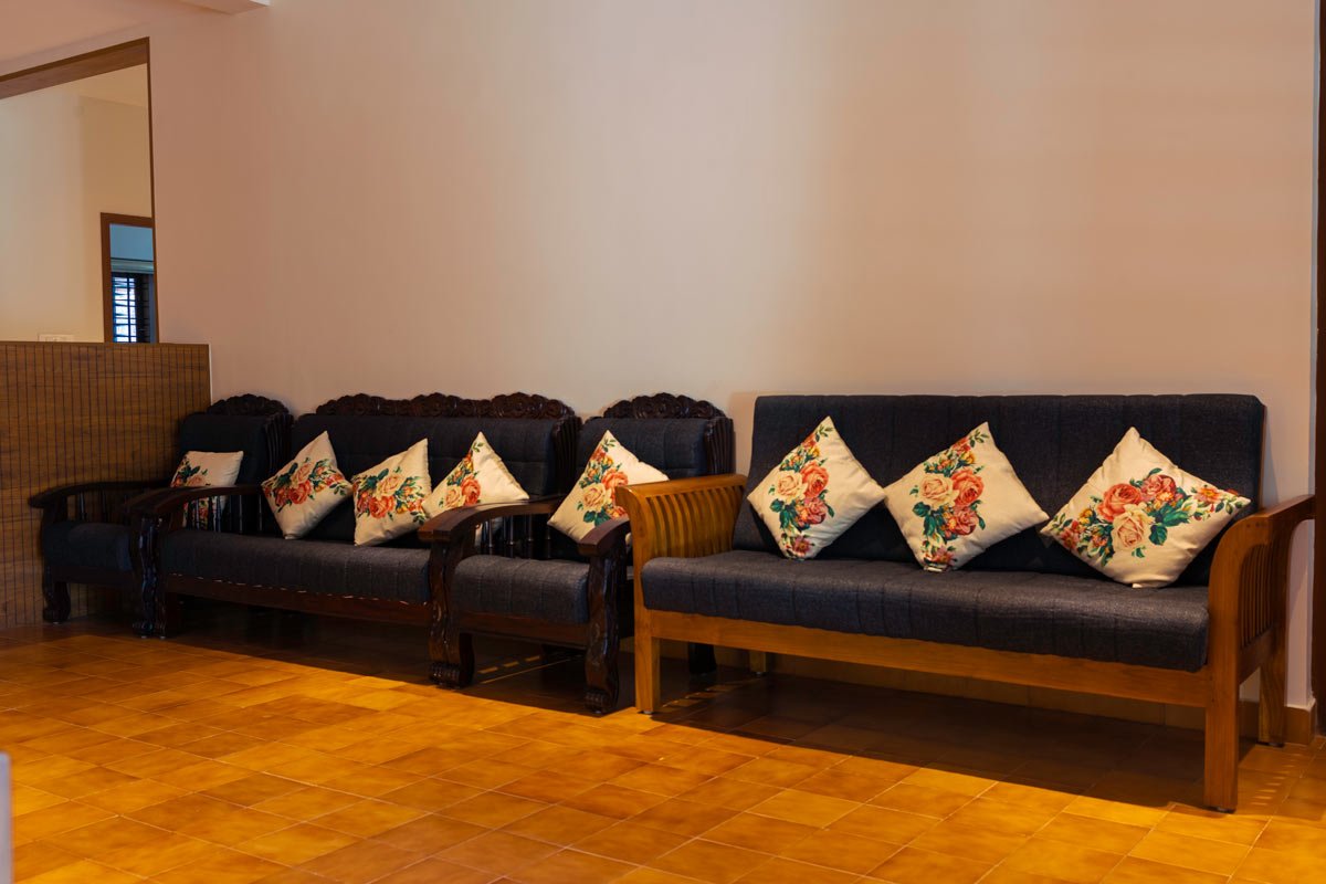 sofa with blue cover and white pillows