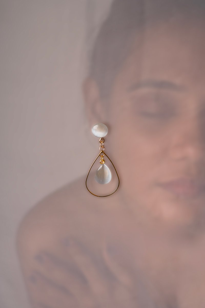 a girl with white and gold ear ring