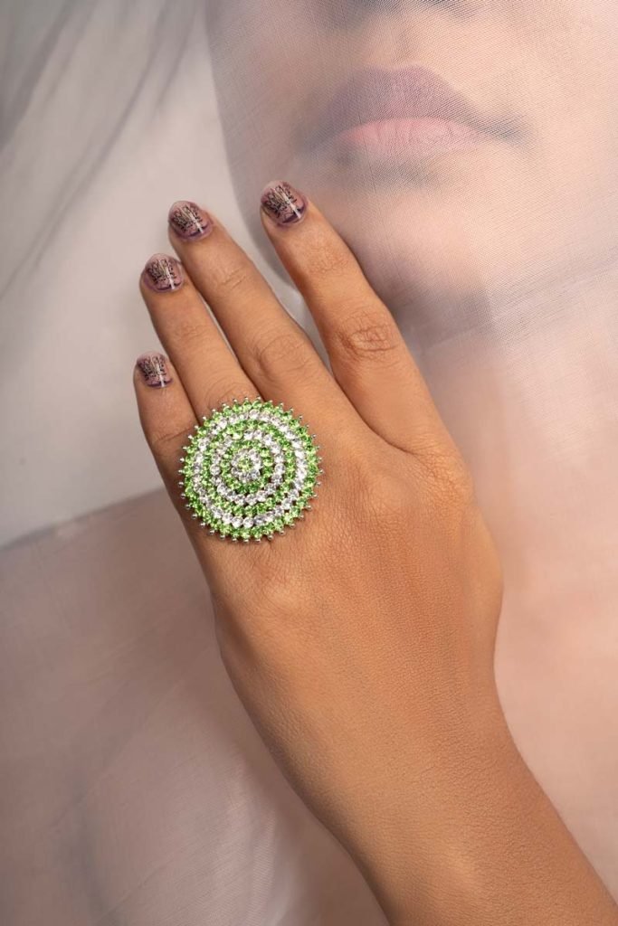 a girl with green stoned ring