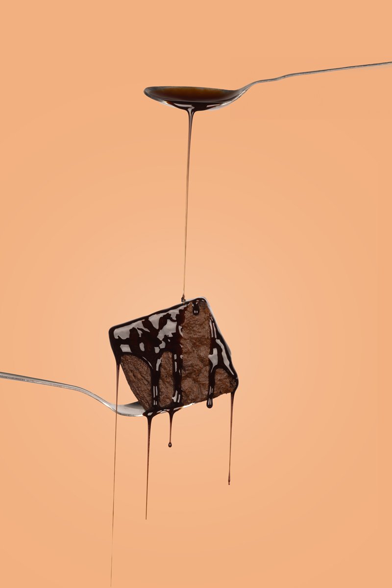chocolate brownie on spone with chocolate syrup