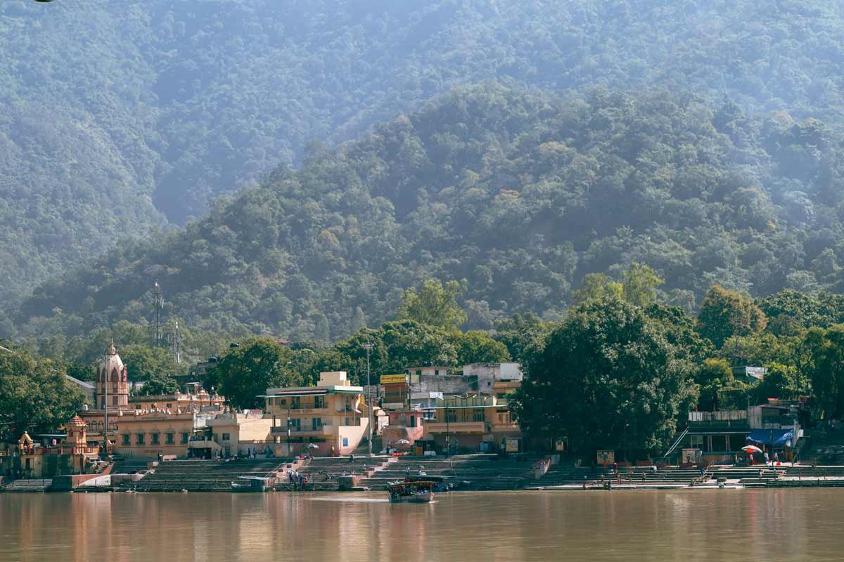 temple on ganga ghat with mountains