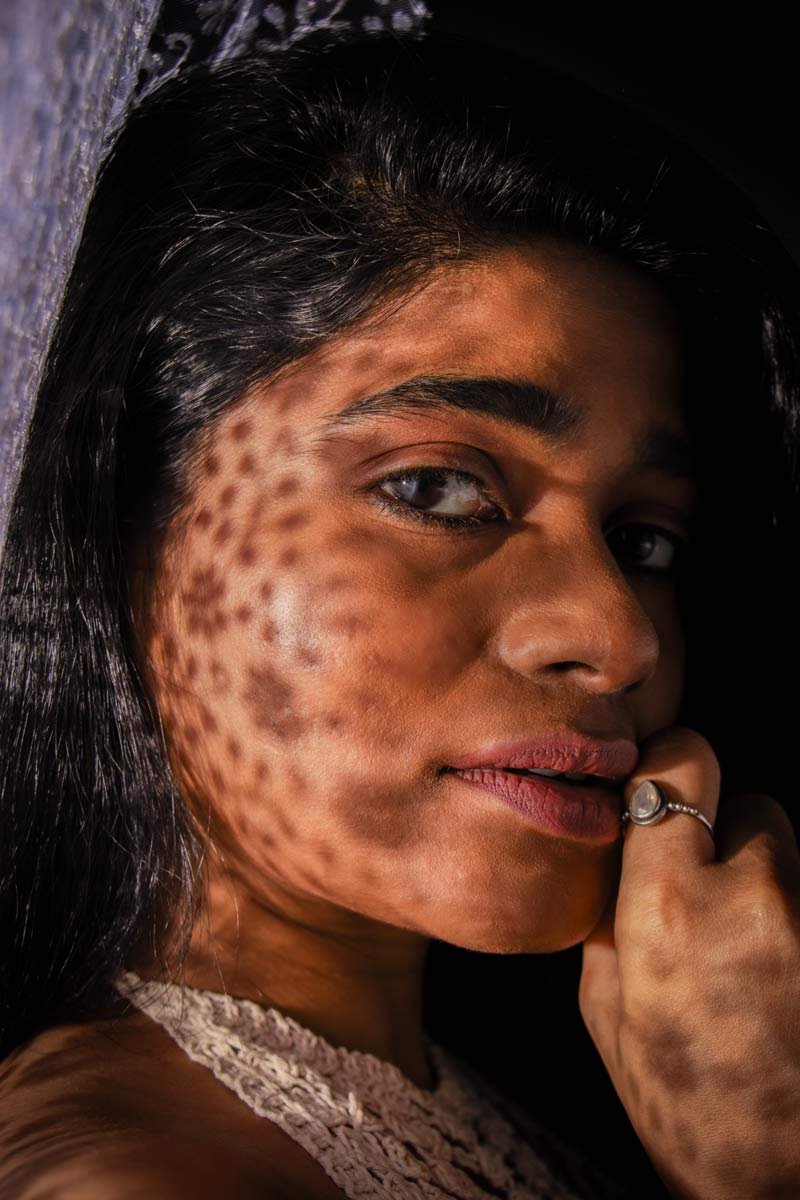 on the girl's face, shadow passes through the lace