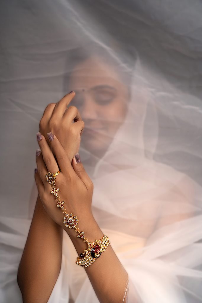 a women with gold stoned bangle from wrist to finger