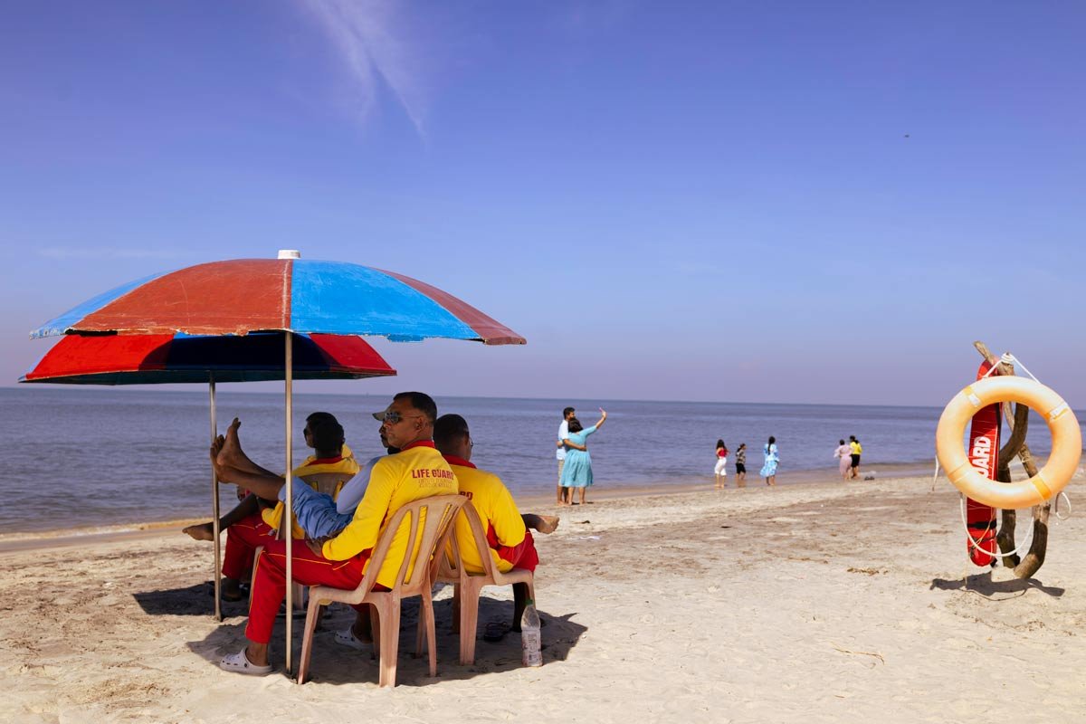 sea guards are sitting on beach