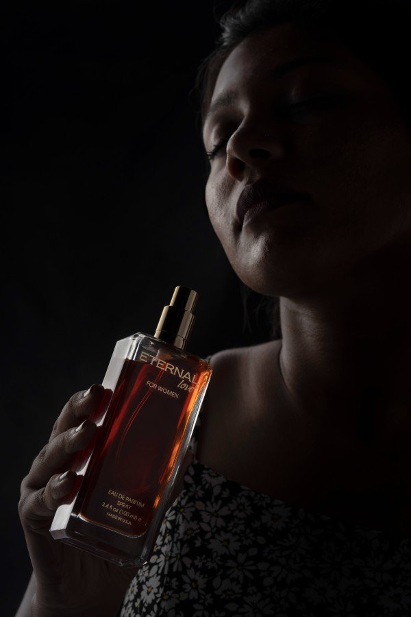 girl holdi a perfume