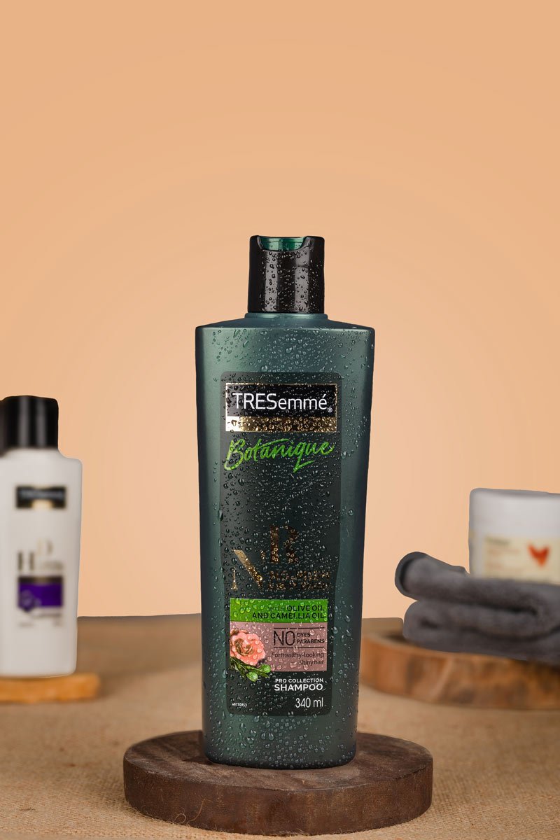 Green shampoo bottle with towel and shower gel