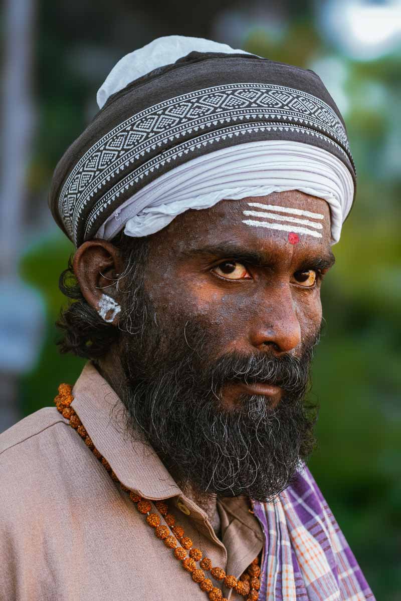 a man who is applying Thilak