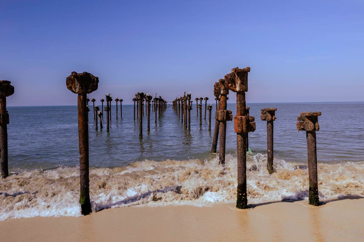 wooden poles in the blue sea