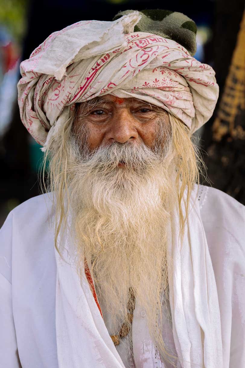 old sadhu with white cloths and white beard