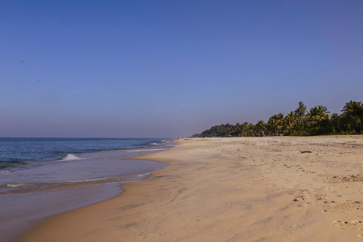 sea coast line with yellow sand and blue sky