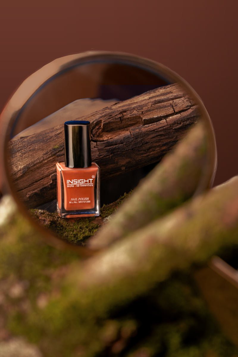 orange nail polish seen in a mirror reflection