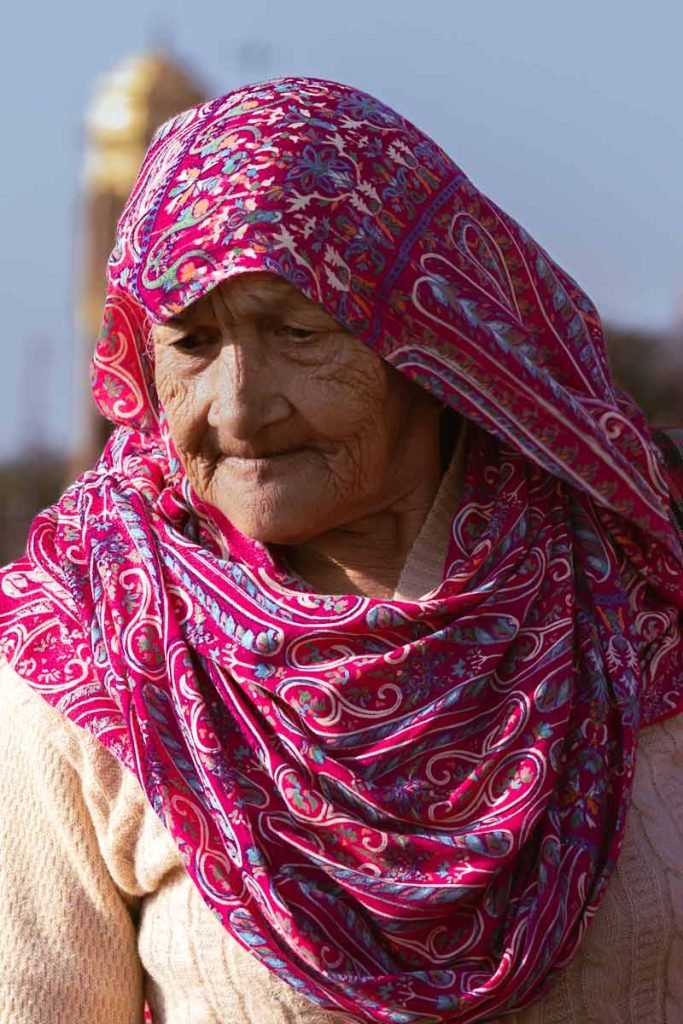 old with pink scarf on his head