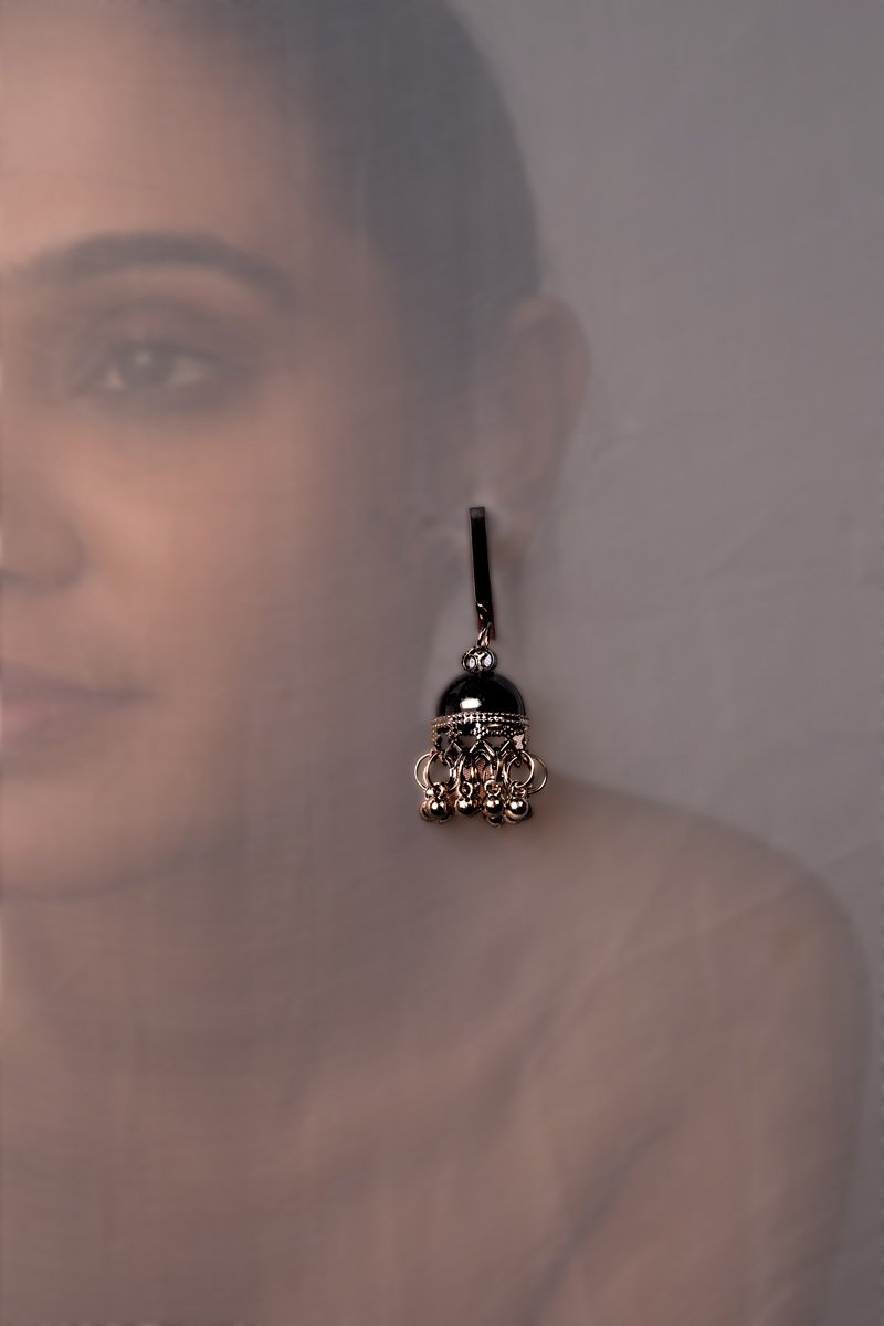 a girl with black ear ring