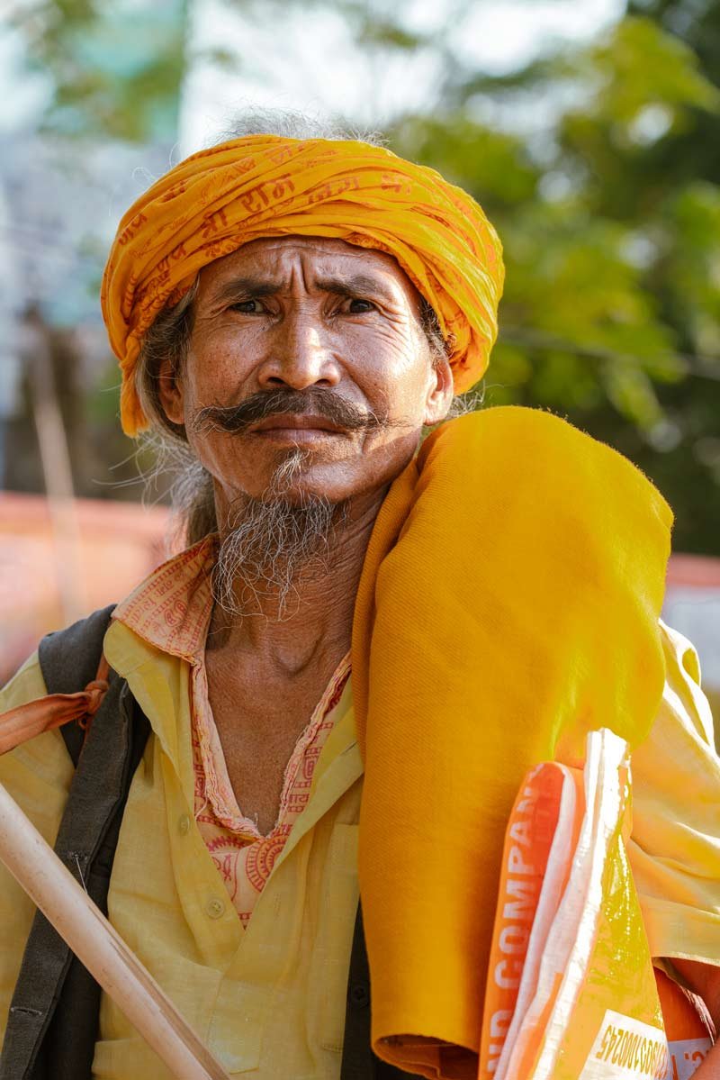 a old man with orange and yellow culture dress