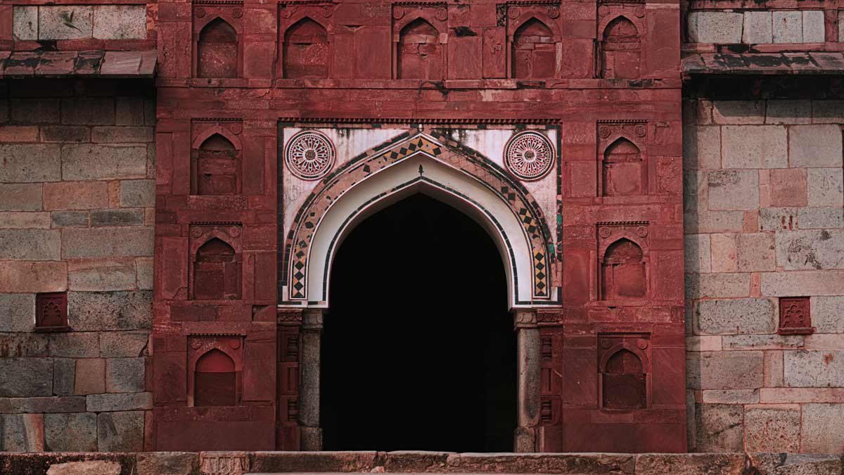 a architecture with red wall and white designed open door