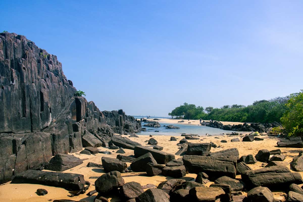 The beach has broken rock.