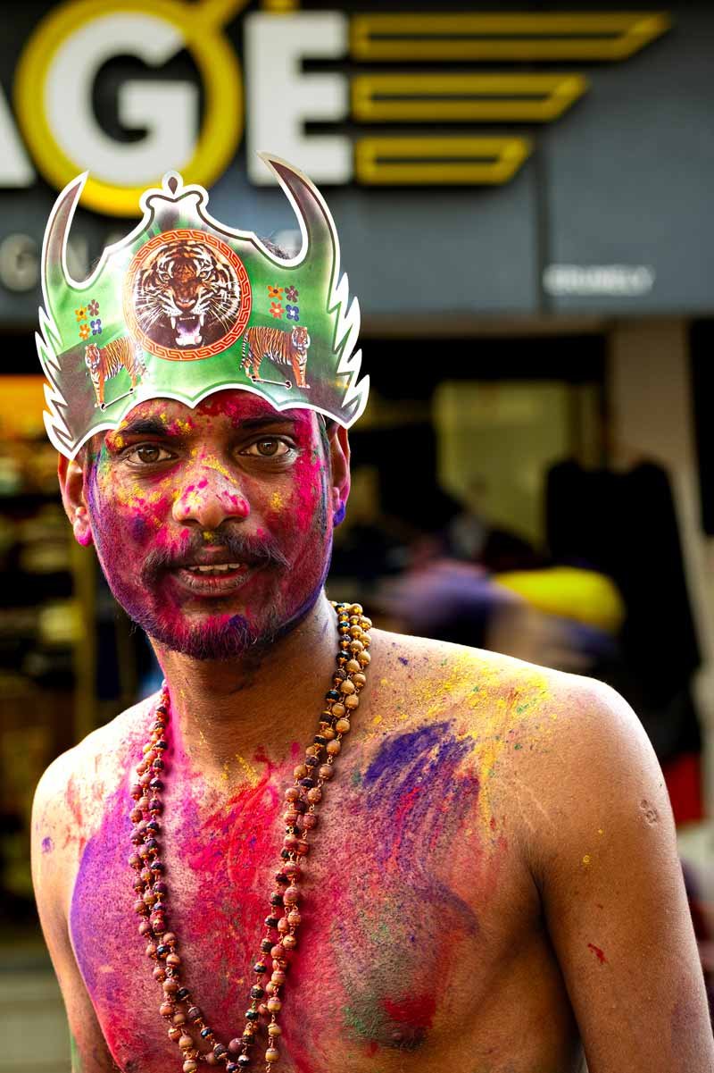 Men with brown eyes and face covered in colours