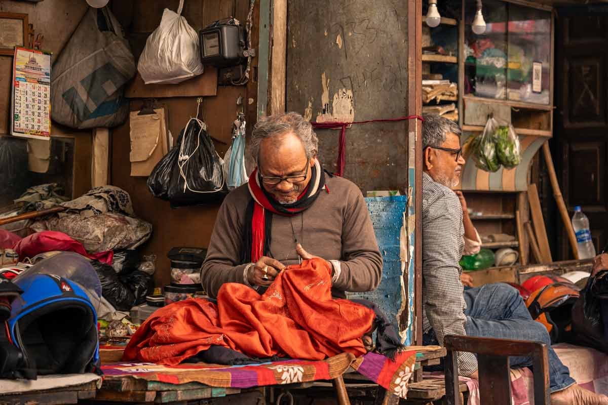 two shopkeeper friends smiling