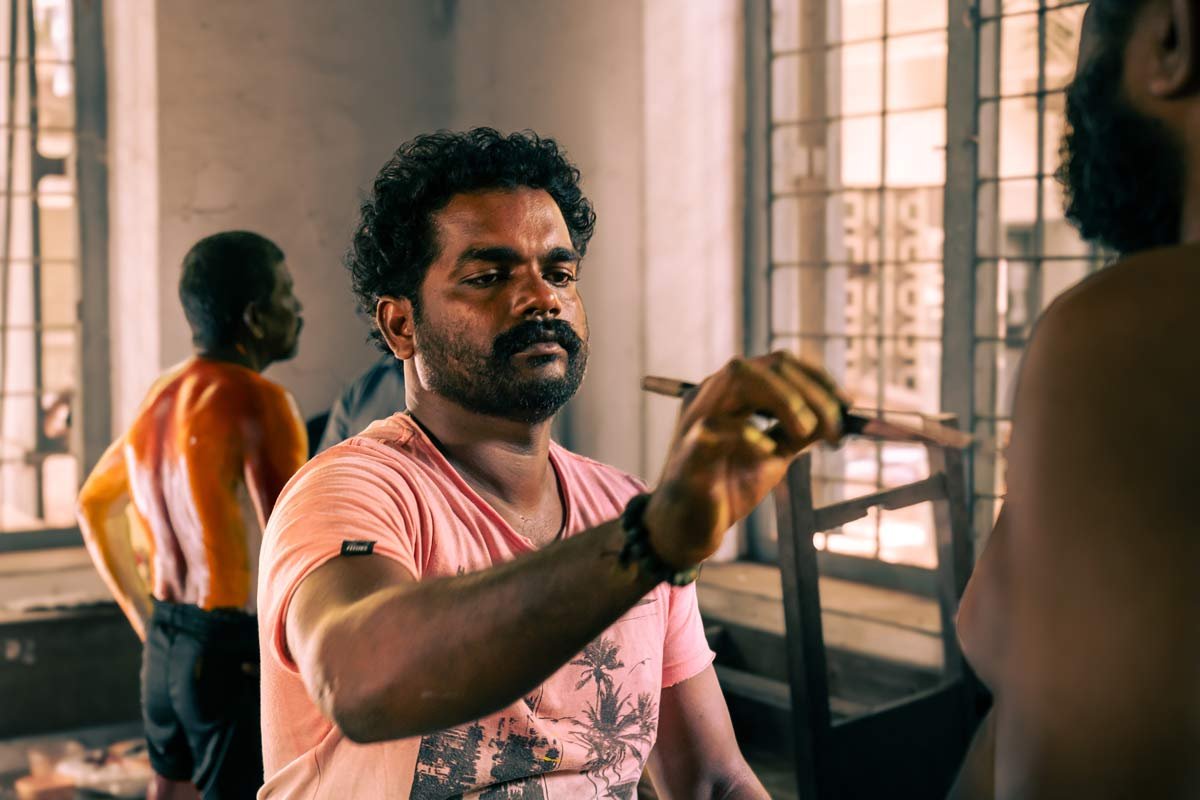 a focused pulikali painter