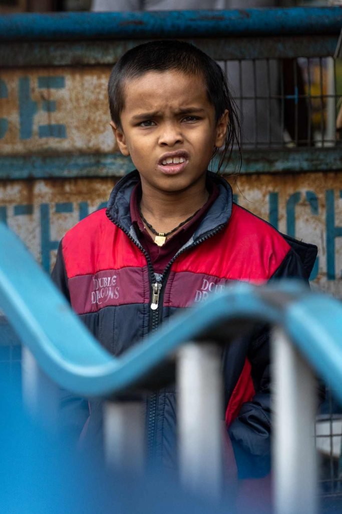 a kid with confused face in the cold