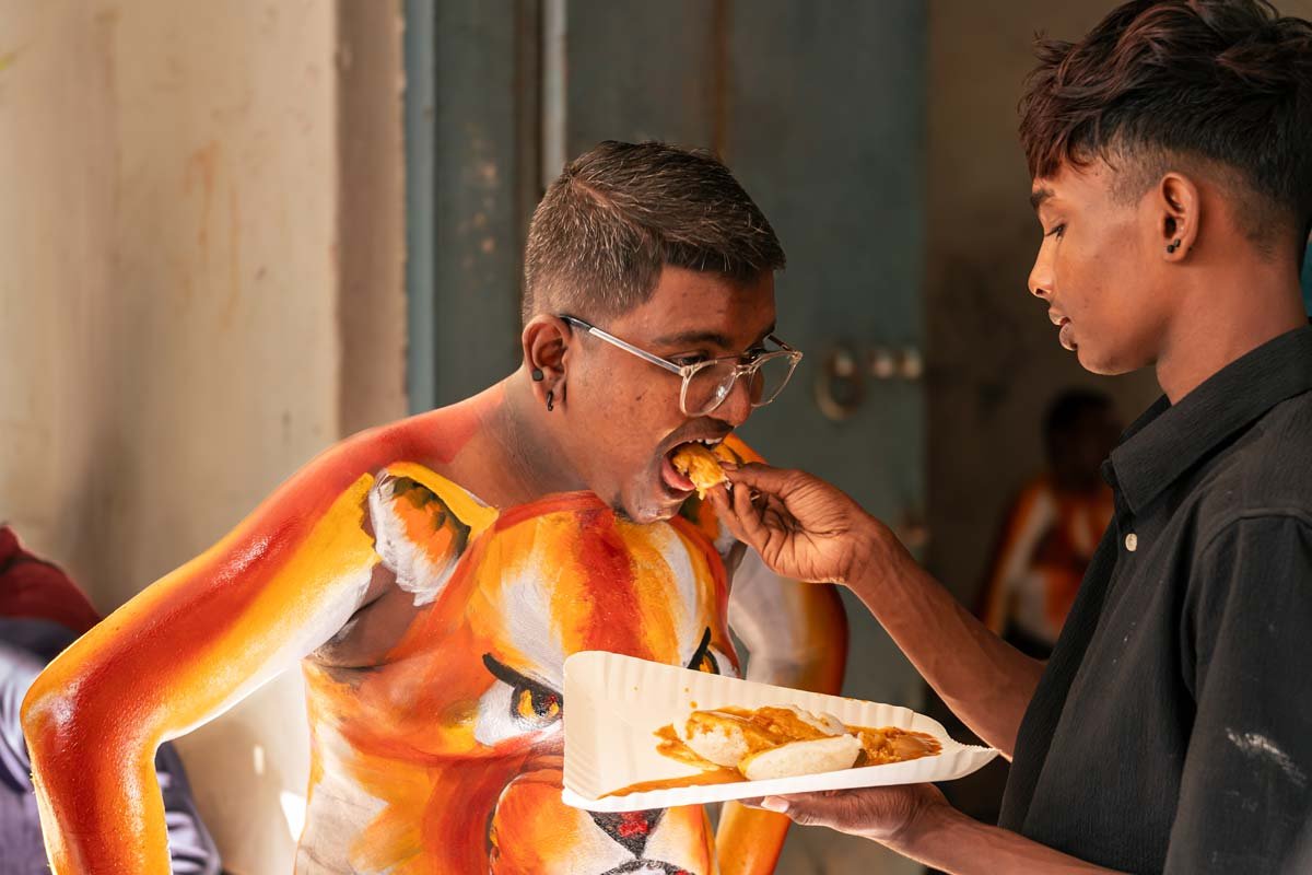 a friend feeding food to the performer