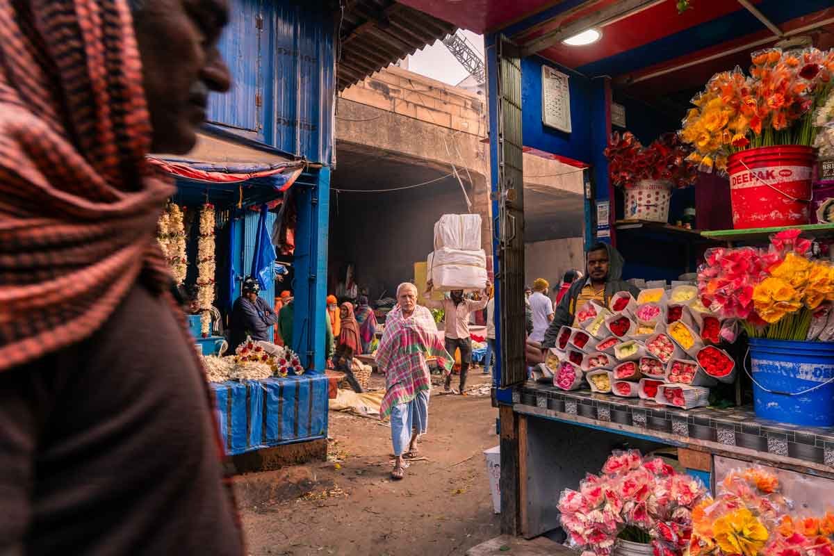a man walking through flower shops