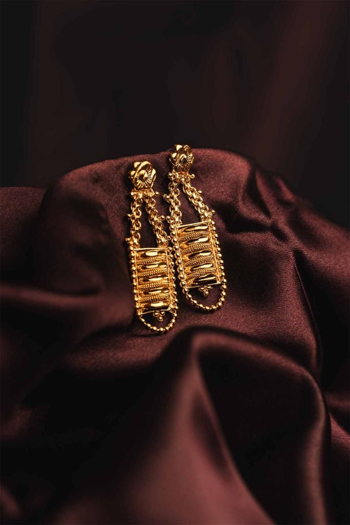 sparkling earrings on cloth