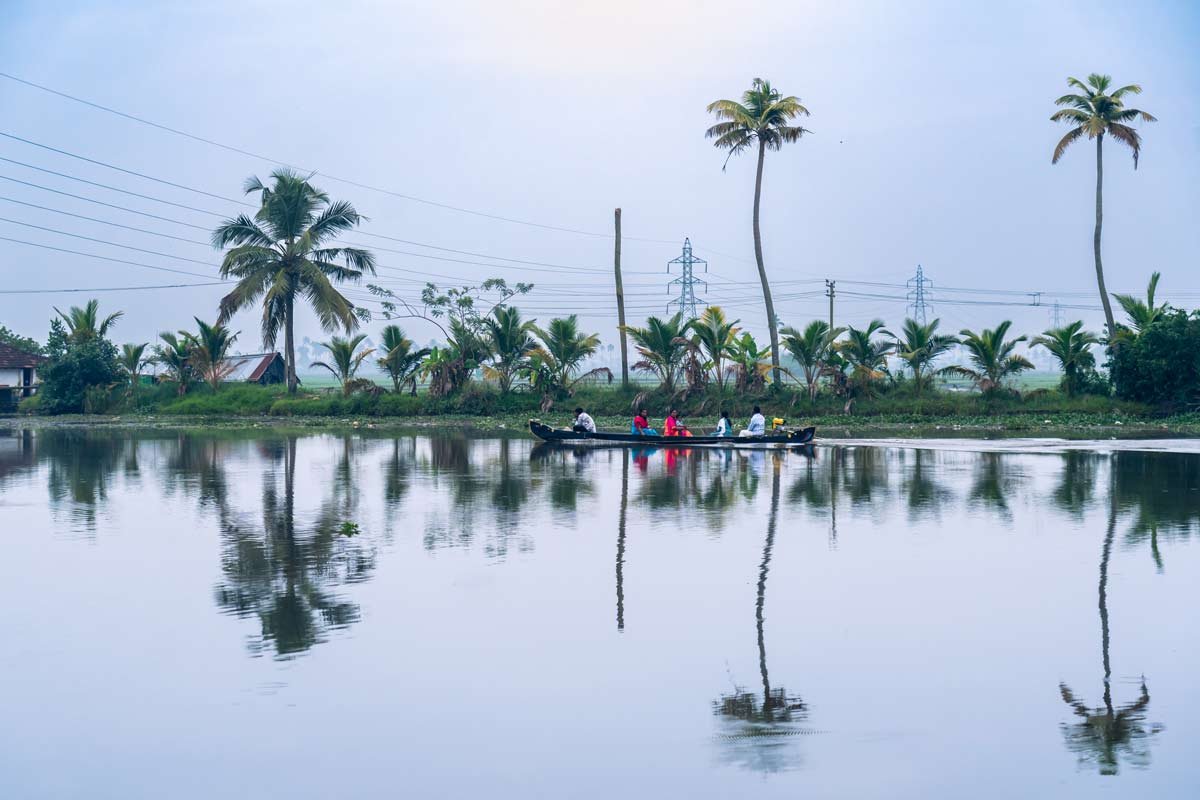 scene of a boat carrying passengers reflected in water