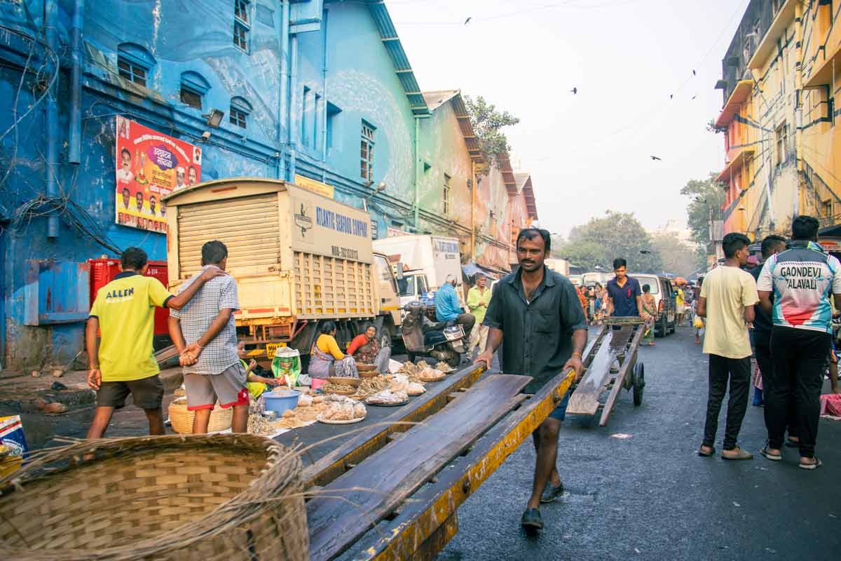 a man carrying cart on the road