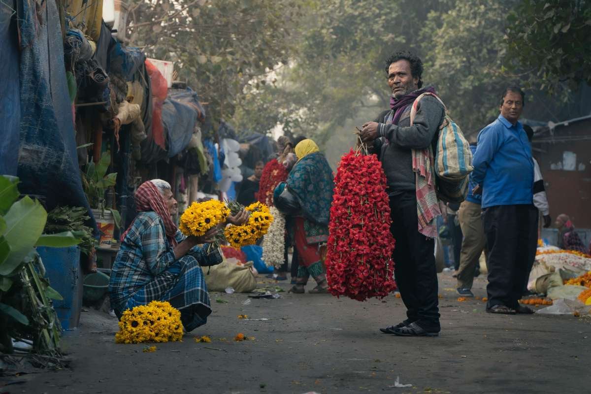 Colorful conversation between two flower sellers.
