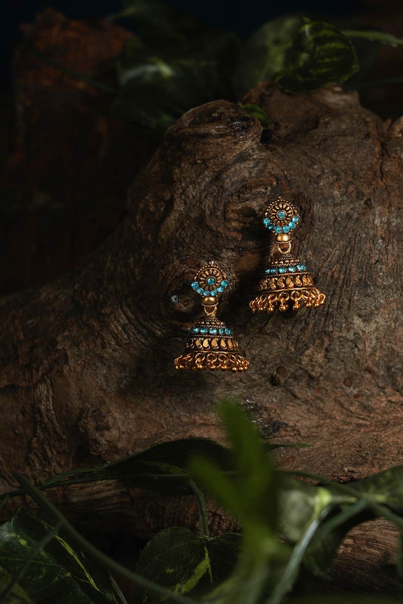 golden dangles hanging on a wooden branch
