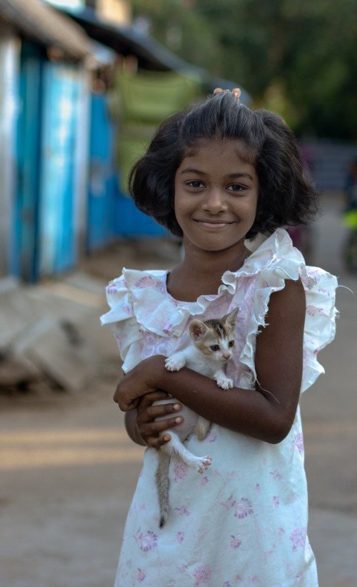 girl holds one cat