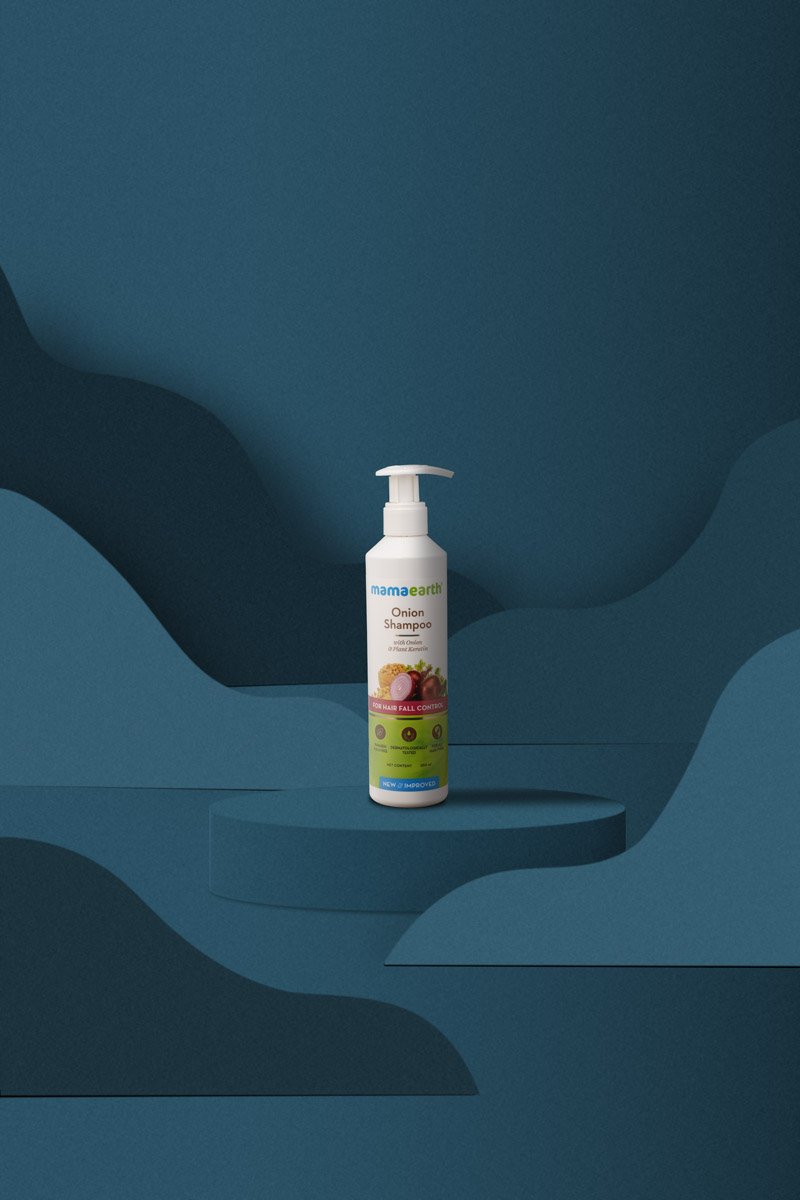 big bottle onion shampoo in a blue background