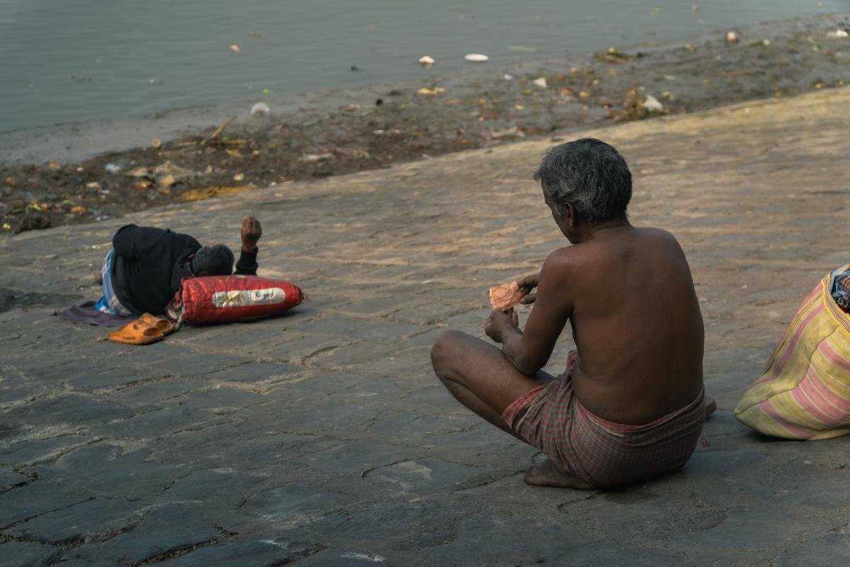 Riverside nap of an old man nearby a river