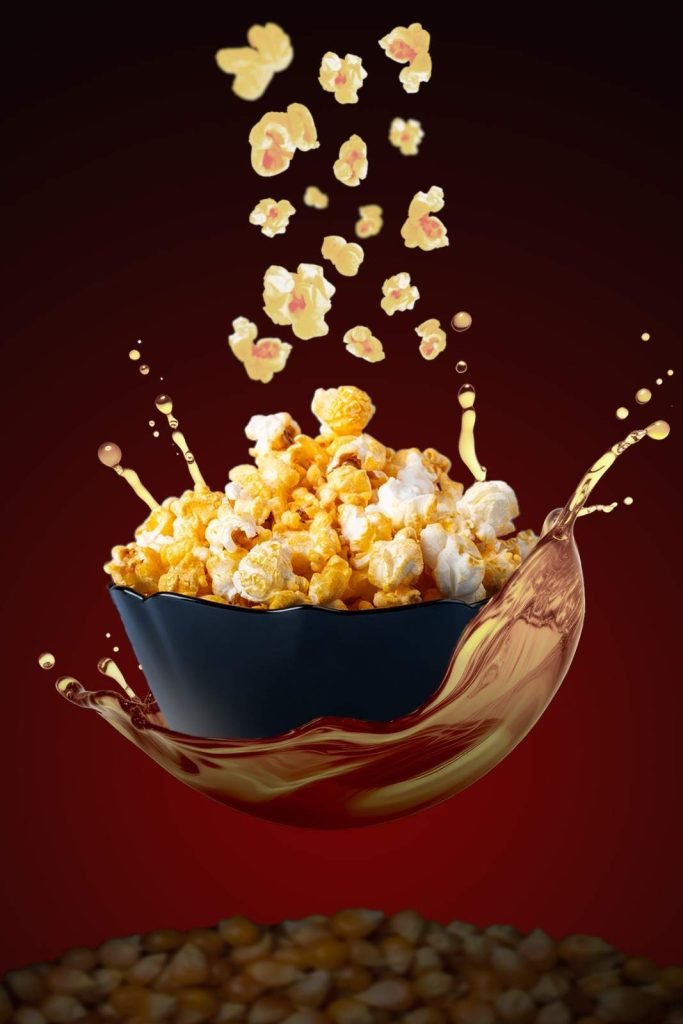 spicy popcorn falling to the bowl and its looks levitating.