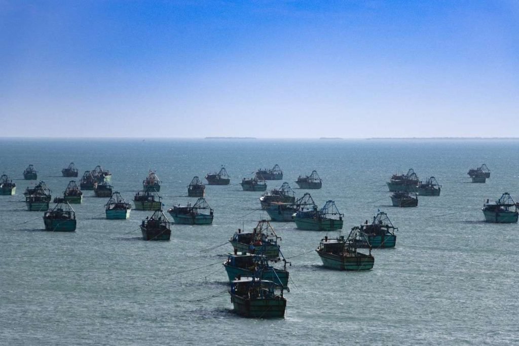 Blue sky over ocean with boats.