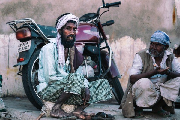 man-sitting -in front-of-a-bike