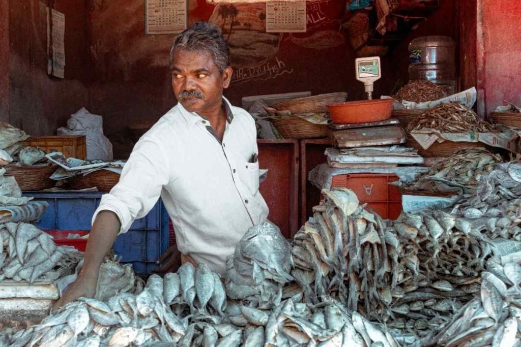 man arranging fish in his stall