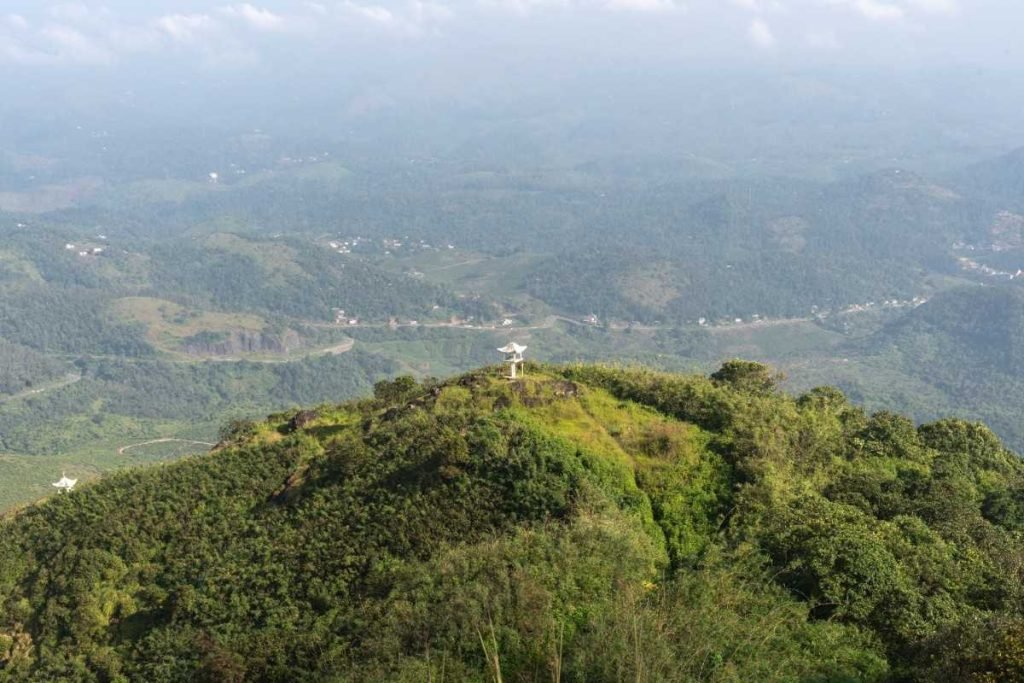 A small chapel on the peak of a mountain.