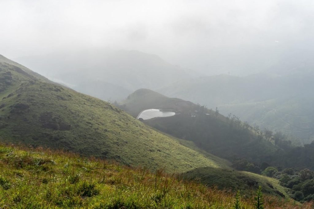 A pool in the middle of two mountains.