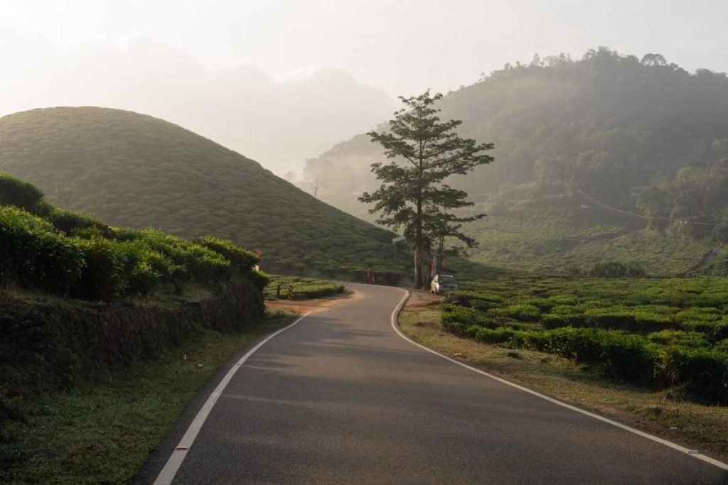 A long road is turning sideways by mountains.