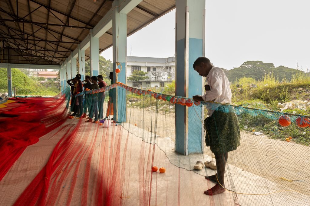 A worker immersed in mending net.